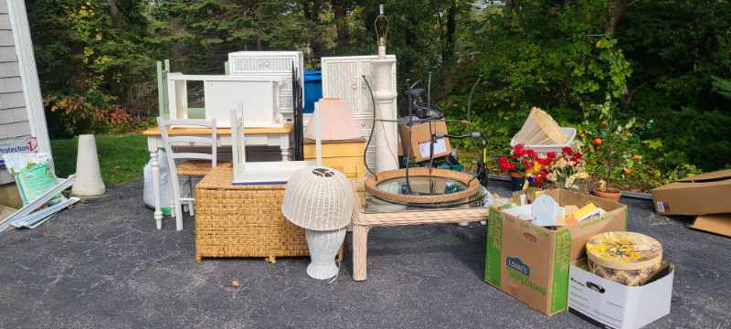 A curbside pile of household junk designated for a discounted pickup